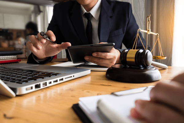 lawyer-working-with-computer-on desk is gavel and lady justice